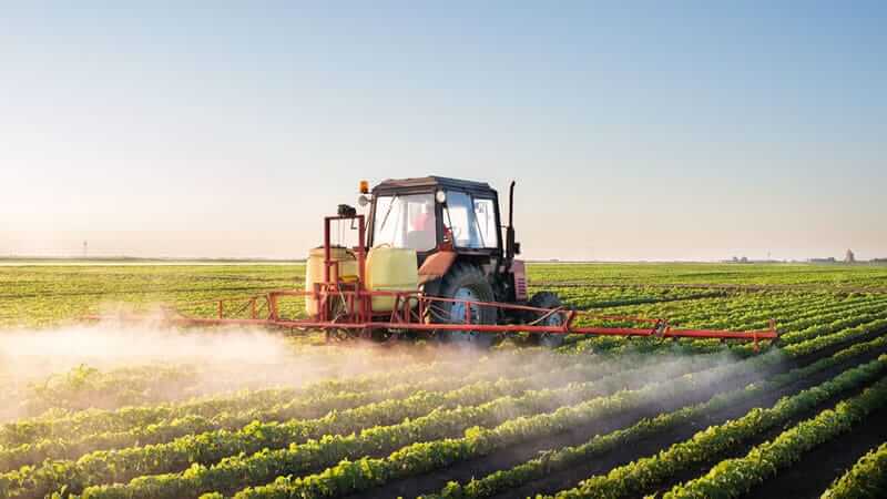 Tractor spraying pesticides in a soybean field for The Whole Soy Story.