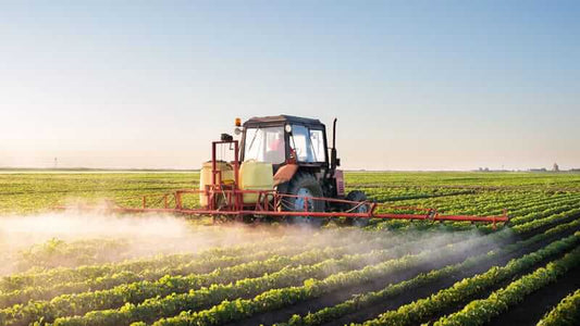 Tractor spraying pesticides in a soybean field for The Whole Soy Story.