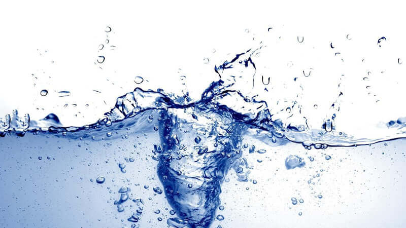 Making Energized Water with splashing blue water in a clear environment, highlighting purity and vitality.