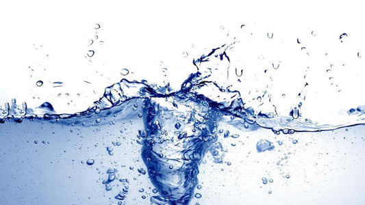 Making Energized Water with splashing blue water in a clear environment, highlighting purity and vitality.