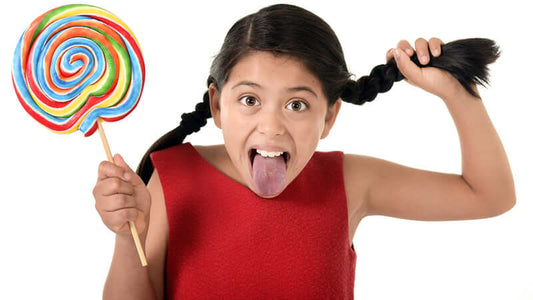 Girl with pigtails holding a giant lollipop, showcasing the fun of sweets in Sugar Blues.