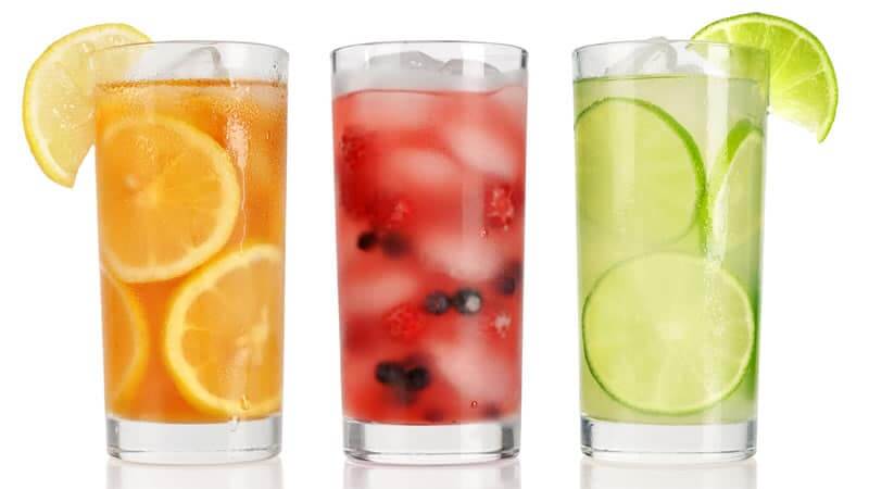 Colorful glasses of fresh juices showcasing the juicing benefits of healthy beverages.