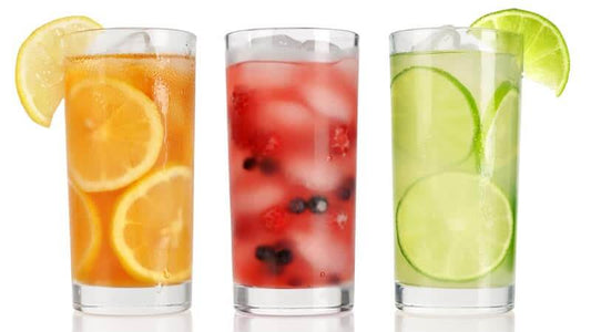 Colorful glasses of fresh juices showcasing the juicing benefits of healthy beverages.