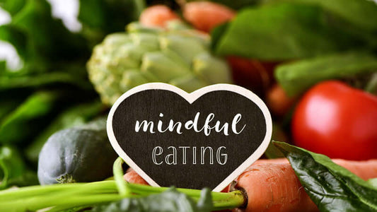 Fresh vegetables with a sign saying 'mindful eating' celebrating How We Eat.