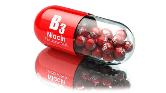 Red capsule with Niacin and B3 for heart health in a reflective setting.