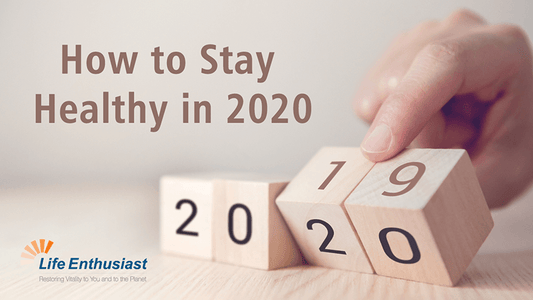 How to Stay Healthy in 2020 with wooden blocks showing the years 2019 and 2020 and a hand adjusting them.