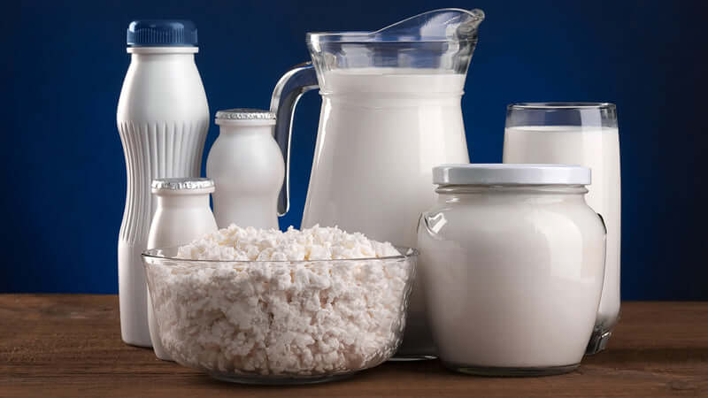 Various containers of milk products showcasing Raw Milk in glass and plastic bottles.