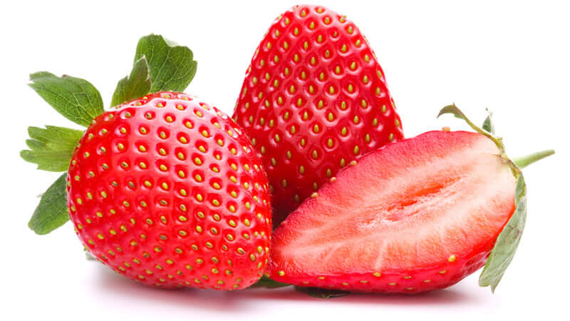 Fresh strawberries with one sliced in half, showcasing their vibrant color and juicy interior.