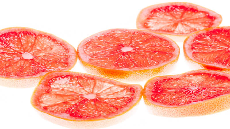 Sliced pink grapefruit showcasing the vibrant interior, highlighting the fruit used in Grapefruit Seed Extract.