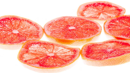 Sliced pink grapefruit showcasing the vibrant interior, highlighting the fruit used in Grapefruit Seed Extract.