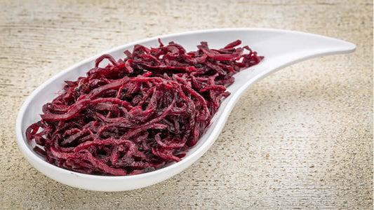 A dish of red algae known as Algae Red served on a white plate, showcasing its vibrant color and texture.