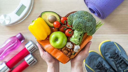 A heart-shaped arrangement of fresh fruits and vegetables representing Basic Nutrition for Health.