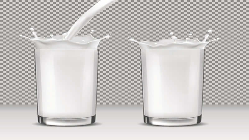 Image of two glasses with splashing milk, illustrating the concept of Milk: Do NOT Drink It.