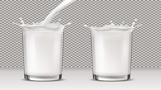 Image of two glasses with splashing milk, illustrating the concept of Milk: Do NOT Drink It.