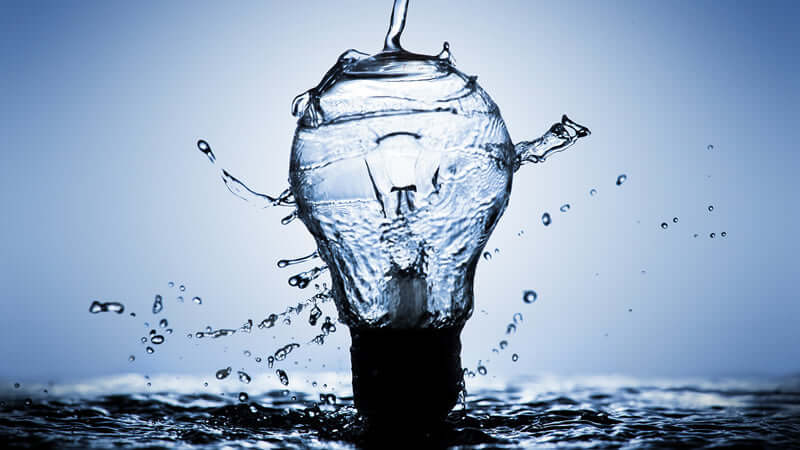Memory of Water depicted through a light bulb splashing water droplets in a creative visual representation.