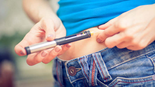 Person injecting insulin using a pen, related to the book Insulin: Our Silent Killer. Book Insulin featured.
