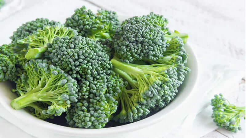 Fresh green Broccoli in a white bowl ready for culinary use or healthy eating.