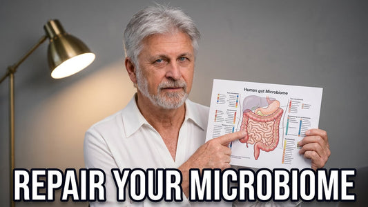 An older man pointing to a diagram of the gut microbiome, representing the gut as the foundation of health.