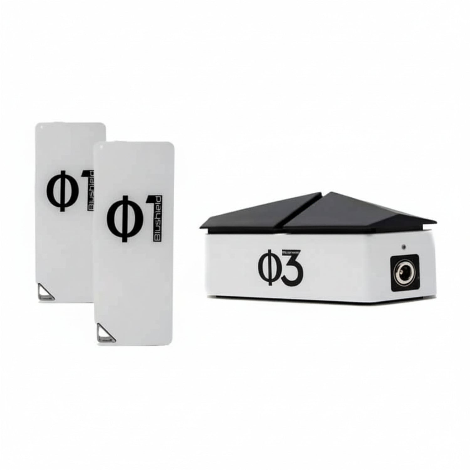 three white devices for EMF protection, two look like cell phones and say Φ1 Blushield, the other has a black top like a roof and says Blushield Φ3