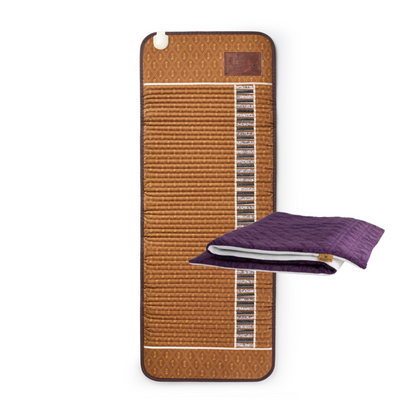 A brown woven cooling mat with a vertical channel of black cooling pads, shown next to a folded purple quilted blanket on a white background.
