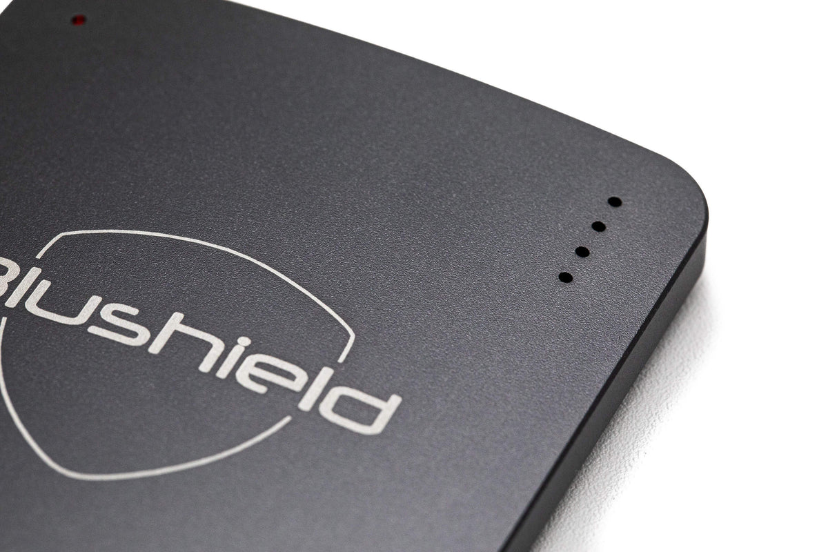 Close-up of the Blushield Ultimate Portable, a compact rechargeable device for personal EMF protection.