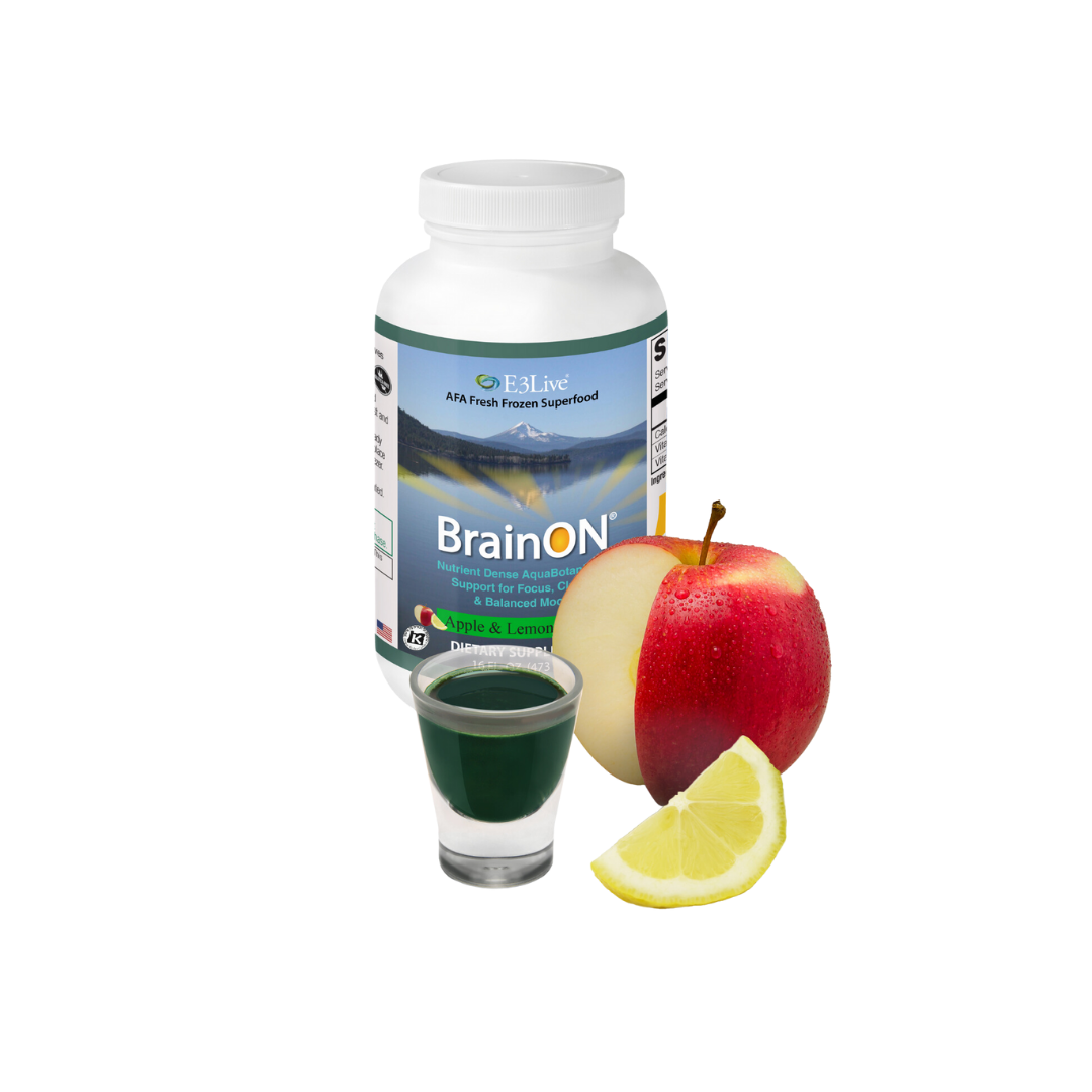 BrainON supplement bottle with a glass of green liquid, apple, and lemon on a white background