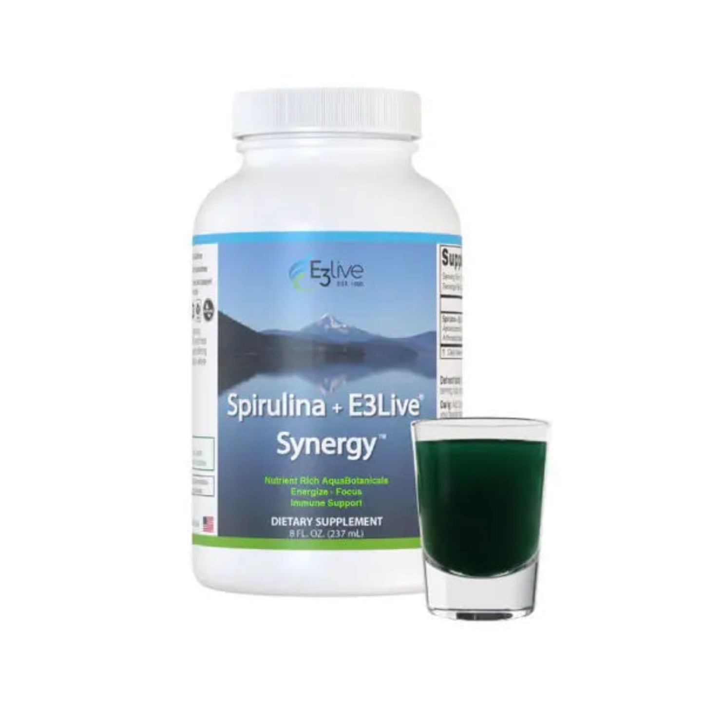 white container with blue and white label with E3Live logo, Spirulina + E3Live Synergy, nutrient rich AquaBotanicals, energize, focus, immune support, dietary supplement 8oz, background image of mountains and lake reflection, and shot glass of green drink