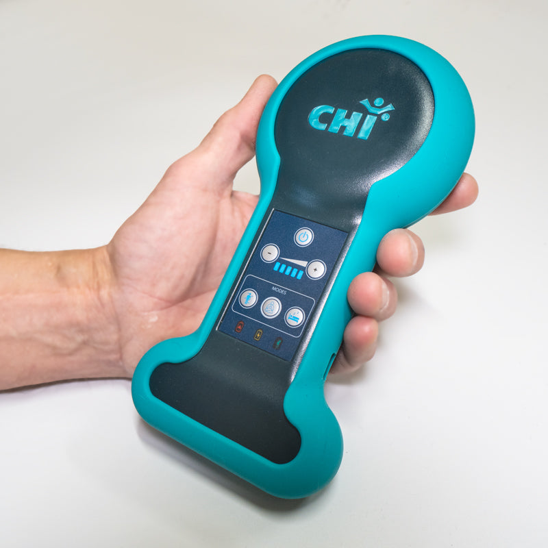 Chi Palm Infratonic Electrotherapy device held in hand for pain relief and relaxation.
