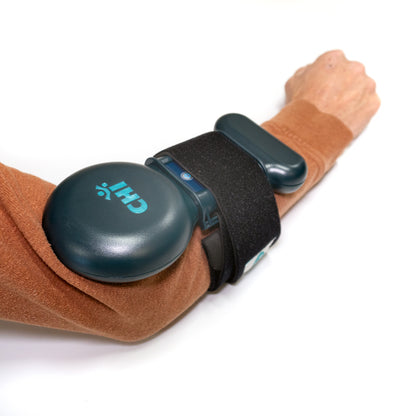 Chi Palm Infratonic Electrotherapy device on arm for pain relief and muscle relaxation.