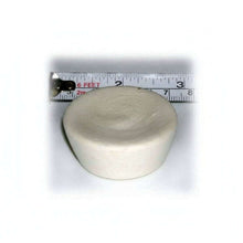 Round ivory cupcake-shaped device with a ruler showing its size on a white background