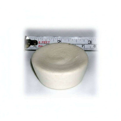 Round ivory cupcake-shaped device with a ruler showing its size on a white background
