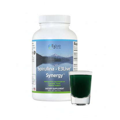 Spirulina supplement bottle with a glass of green liquid on a white background