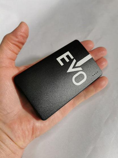 Hand holding a black Portable Device 'EVO' branding on a light gray background