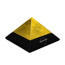Evo Pyramid by Blushield, a golden EMF protection device in a sleek black base design.