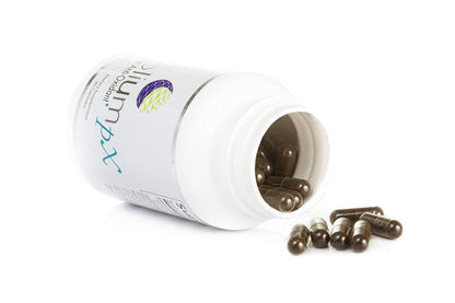 Open bottle of Nutricentials with loose capsules on a white background