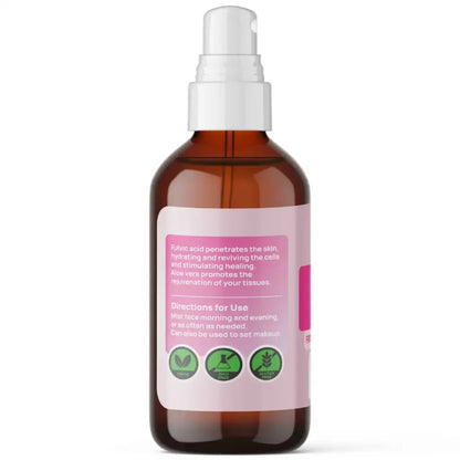 Brown glass bottle with a white spray nozzle on a white background