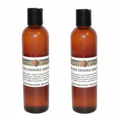 Two amber-colored bottles of Third Eye Chakra ORMUS with black caps on a white background