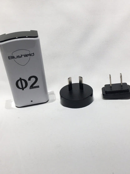 Blushield electronic device with two plug adapters on a white background