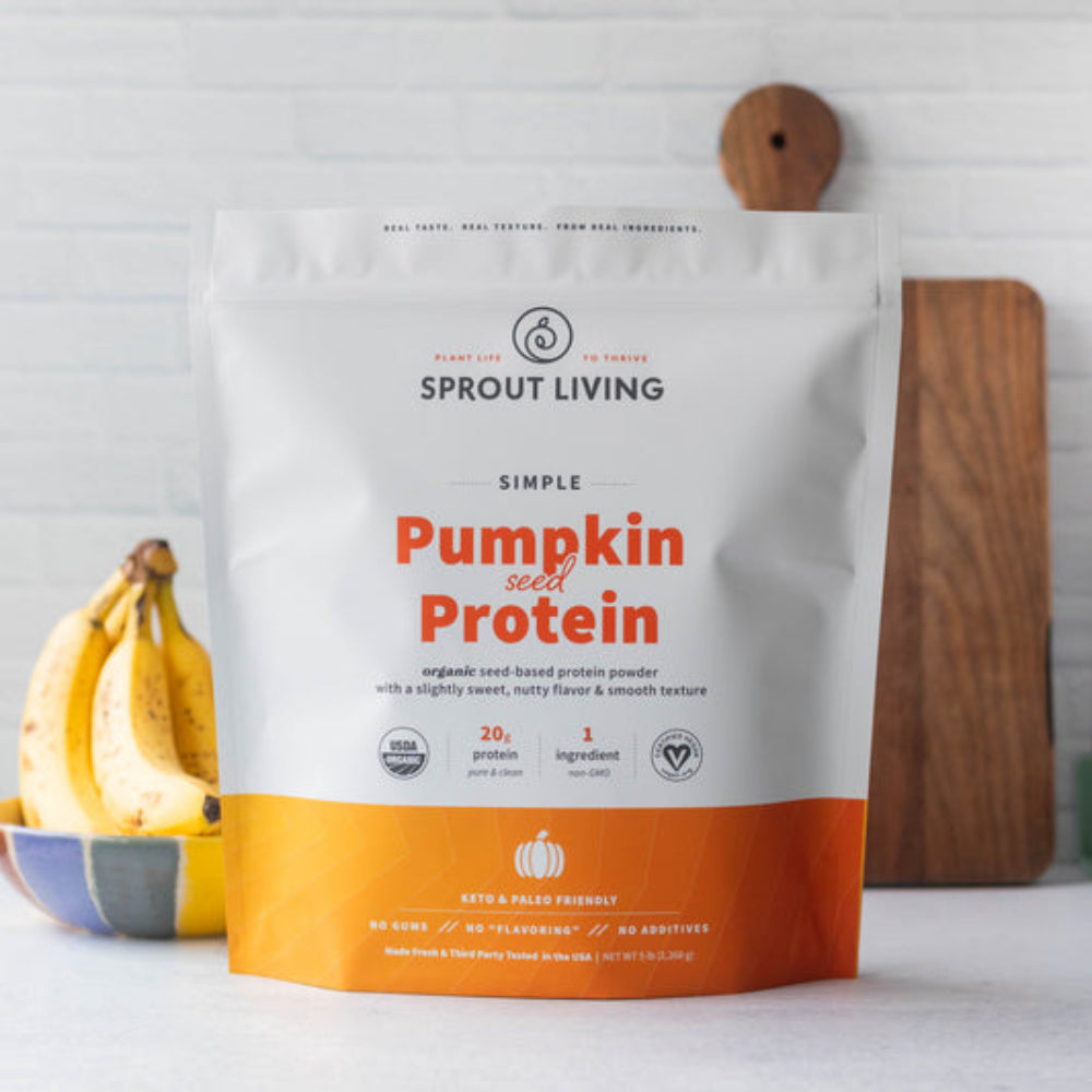 Sprout Living pumpkin seed protein package with bananas and a cutting board in the background