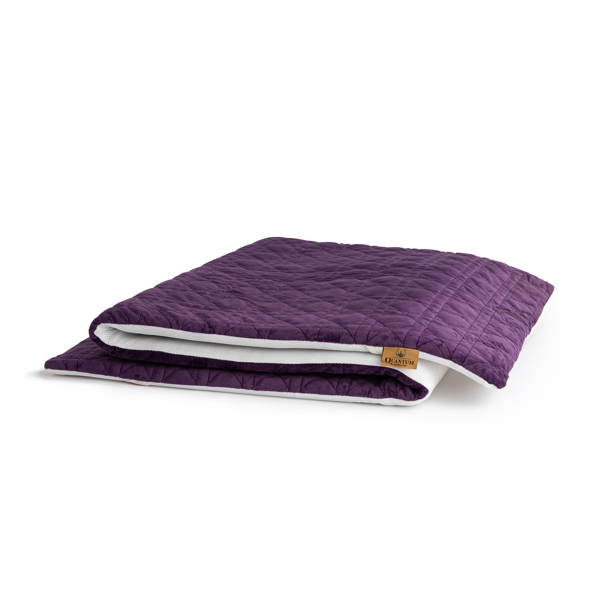 A folded purple quilted mattress protector or comforter with a white inner lining and a small tan brand tag, shown on a clean white background.
