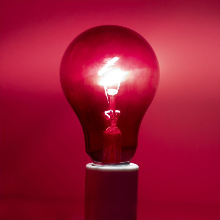 Light bulb glowing red against a red background
