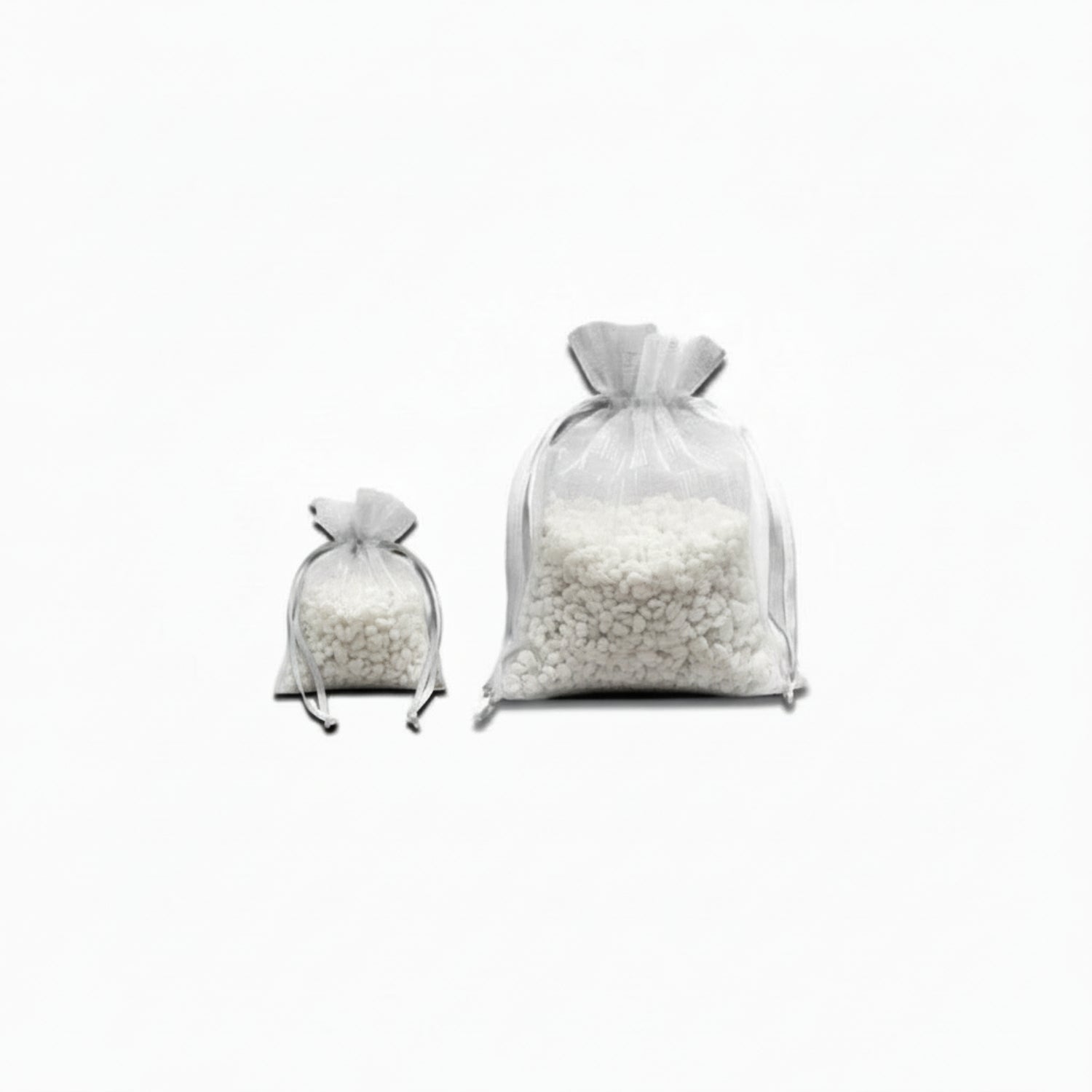 Two white satchels full of small white 'rocks' on a white background