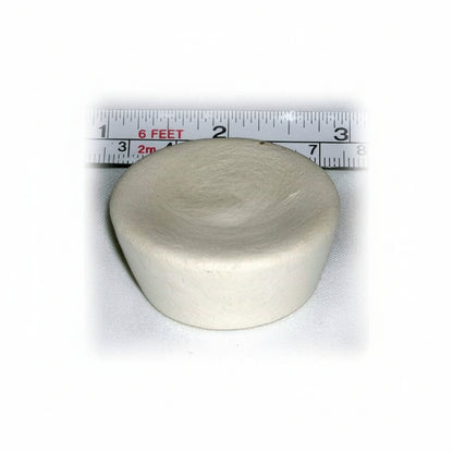 Round ivory cupcake-shaped device with a ruler showing its size on a white background
