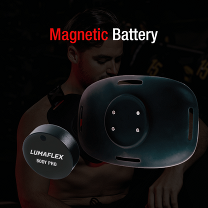 Lumaflex Body Pro magnetic battery device held by a person with a dark background