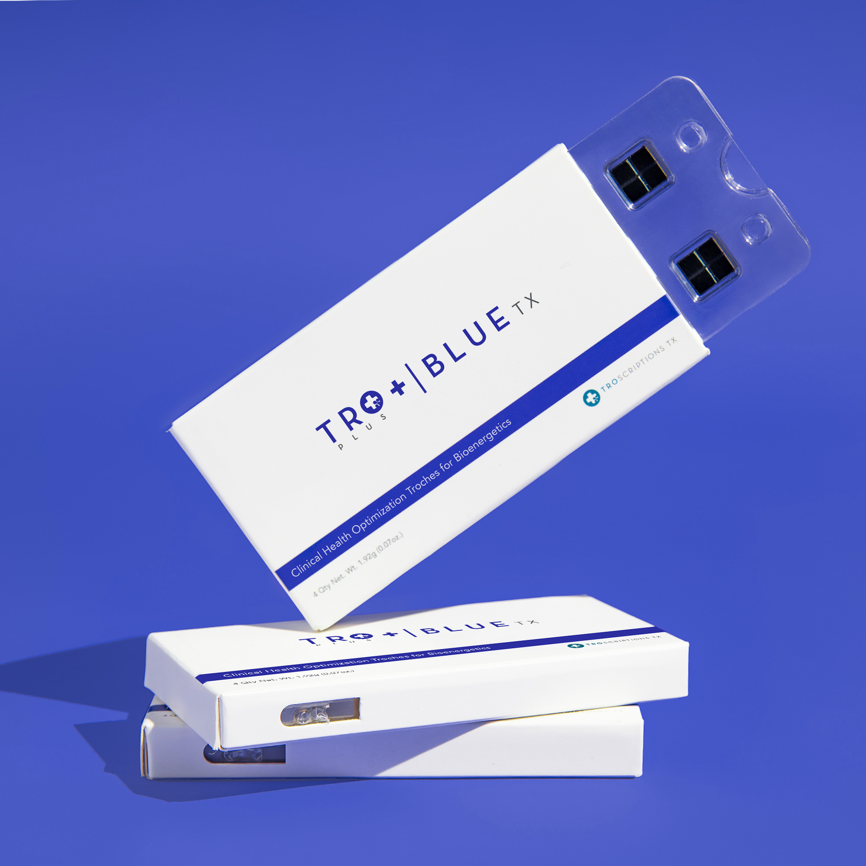 Tro+ Blue buccal troches for focus and energy in packaging on a blue background.