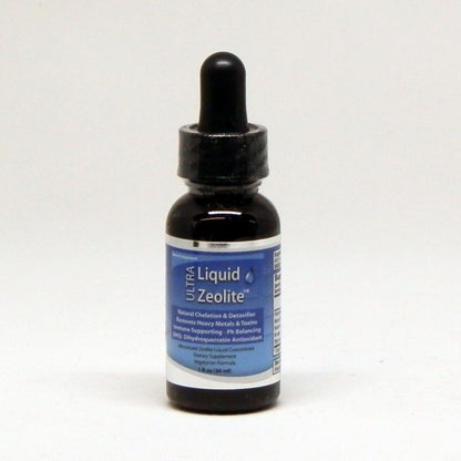 A small dark amber glass dropper bottle of Ultra Liquid Zeolite with a black dropper cap and a blue-and-white label, centered on a plain light background.