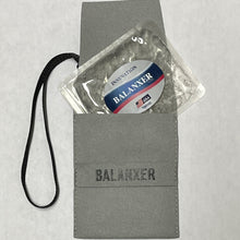 Gray pouch with a 'Balanxer' package on a light gray background