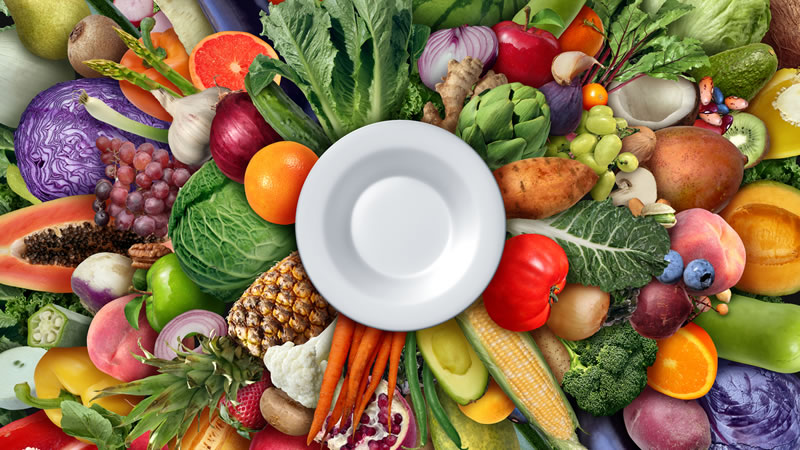 healthy fresh foods surrounding white plate
