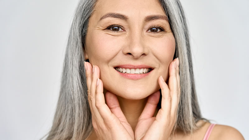 smiling healthy woman with grey hair and beautiful skin