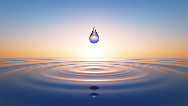 drop of water hanging above ocean